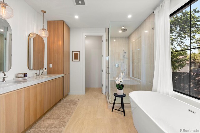 332 S Franklin St, Denver, CO 80209 - full bath featuring a stall shower, a freestanding tub, double vanity, and recessed lighting