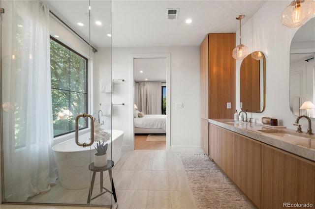 332 S Franklin St, Denver, CO 80209 - full bathroom featuring plenty of natural light, double vanity, a freestanding bath, recessed lighting, and connected bathroom