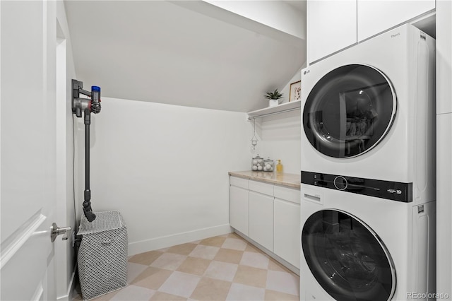 332 S Franklin St, Denver, CO 80209 - laundry area with stacked washer and clothes dryer, light flooring, and cabinet space
