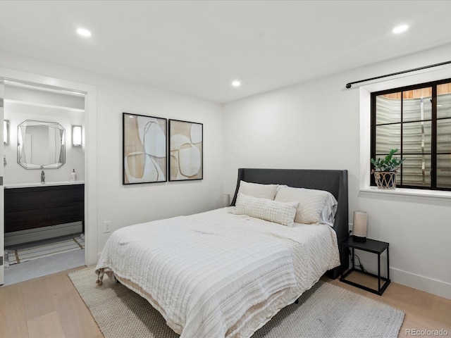 332 S Franklin St, Denver, CO 80209 - bedroom featuring recessed lighting, wood finished floors, and connected bathroom