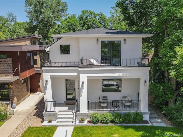 332 S Franklin St, Denver, CO 80209 - view of front facade featuring a balcony, covered porch, and stucco siding