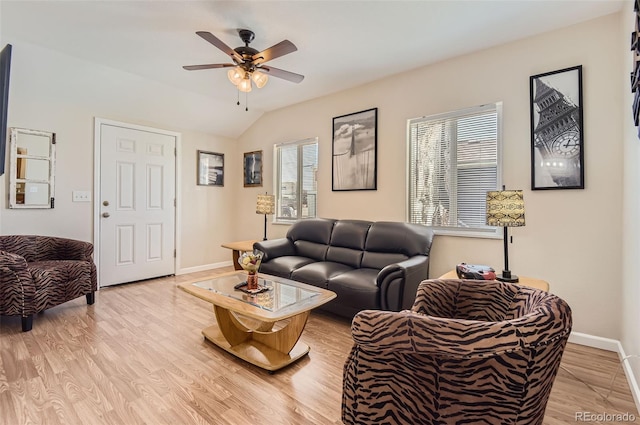 living room with lofted ceiling, ceiling fan, light wood-type flooring, and a wealth of natural light