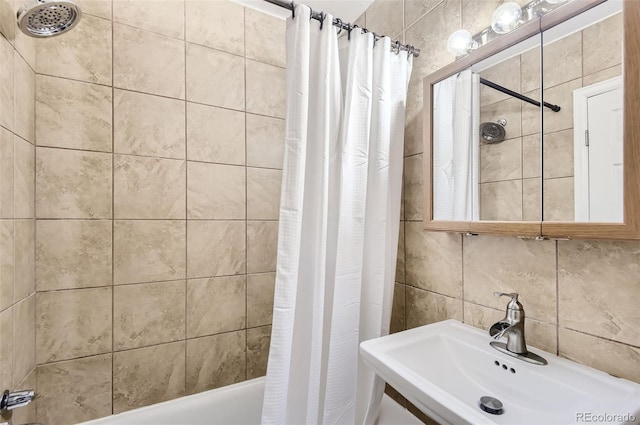 bathroom featuring tile walls, vanity, decorative backsplash, and shower / tub combo