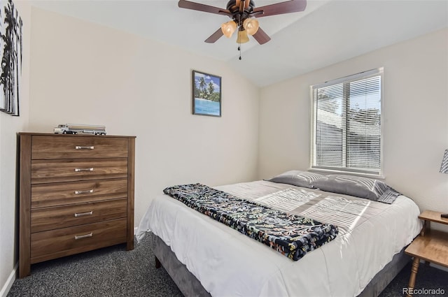 bedroom featuring dark carpet, lofted ceiling, and ceiling fan