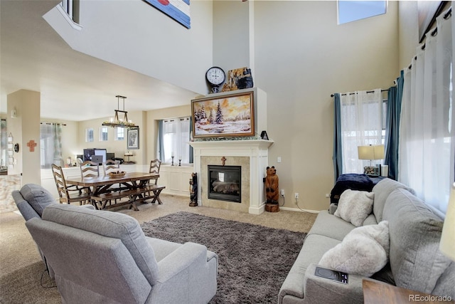 carpeted living room with a tiled fireplace and a towering ceiling