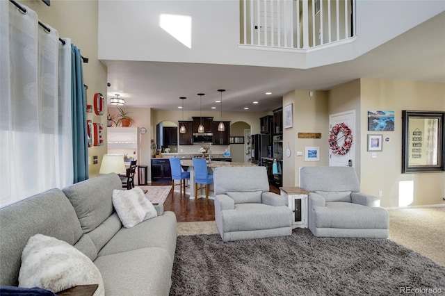 living room featuring a towering ceiling