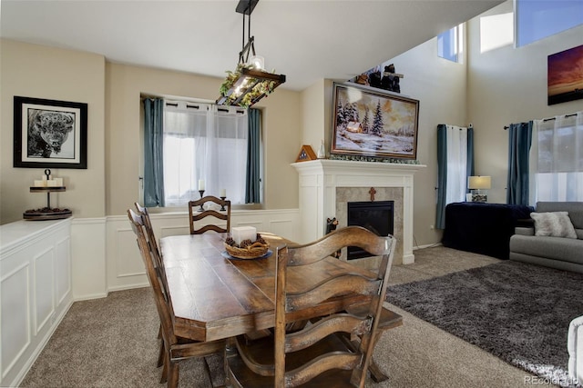 carpeted dining room with a fireplace