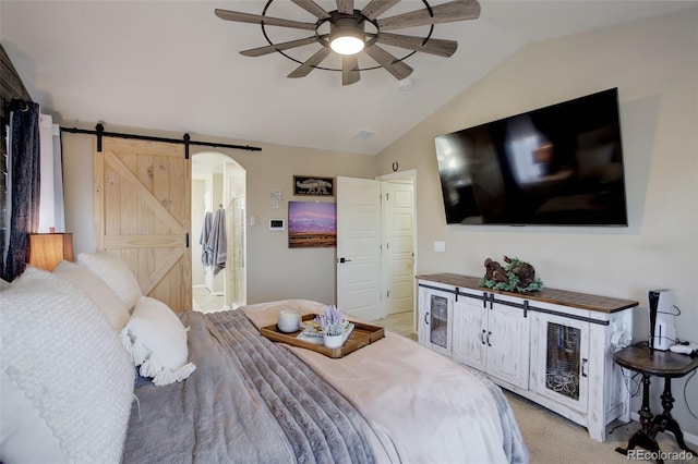 carpeted bedroom with vaulted ceiling, a barn door, and ceiling fan