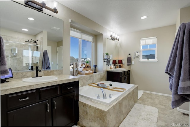 bathroom with vanity, plenty of natural light, tile patterned floors, and independent shower and bath