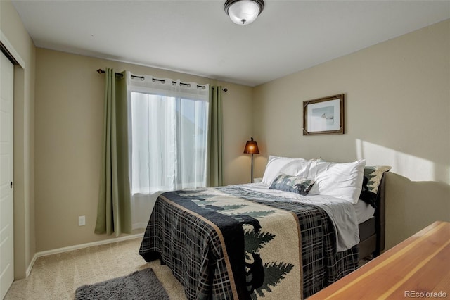 bedroom featuring light carpet and a closet