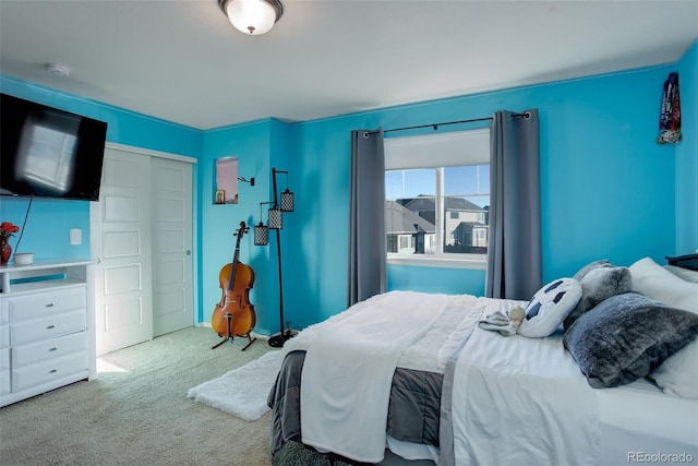 bedroom with light colored carpet and a closet