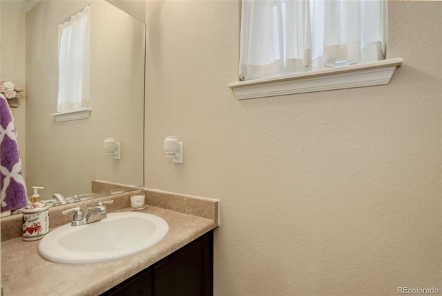 bathroom with vanity and plenty of natural light