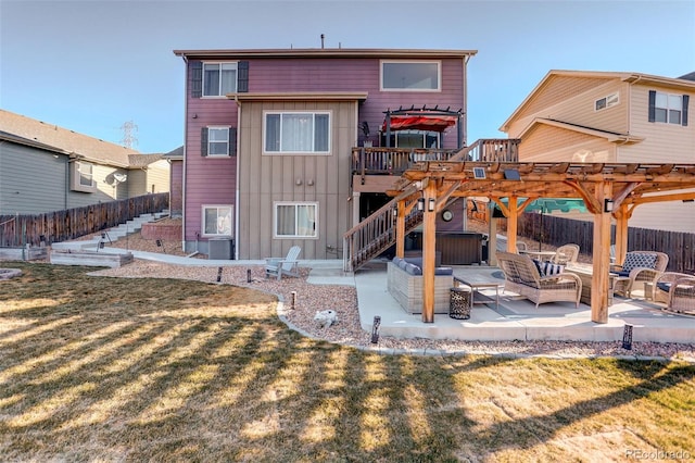 rear view of property with a yard, a pergola, an outdoor living space, and a patio