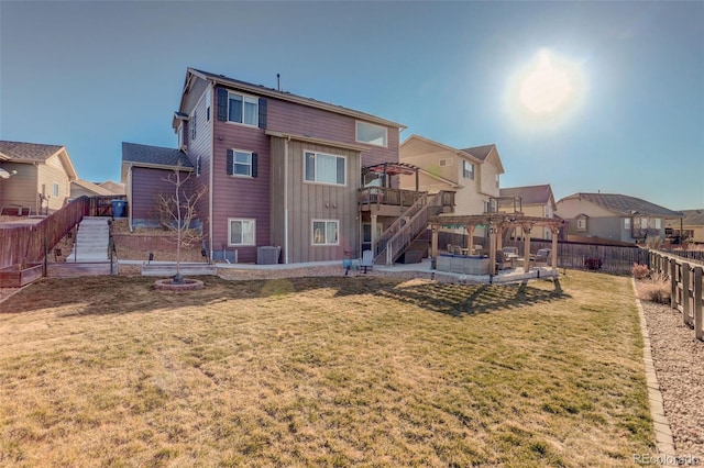 back of house with a yard, central AC, a deck, and a pergola