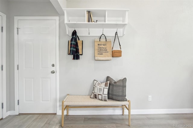 mudroom featuring baseboards and wood finished floors
