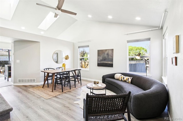 living room featuring ceiling fan, recessed lighting, wood finished floors, a skylight, and visible vents