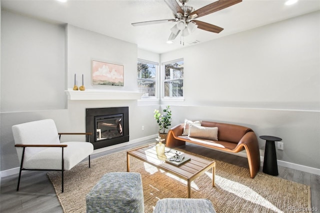 living room with baseboards, recessed lighting, a glass covered fireplace, and a ceiling fan