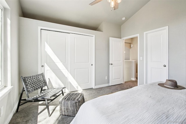 carpeted bedroom with baseboards, a ceiling fan, a closet, and lofted ceiling