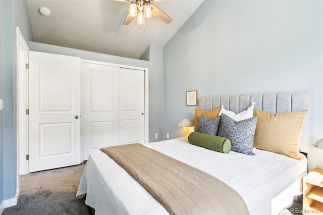 carpeted bedroom with a closet, ceiling fan, and vaulted ceiling