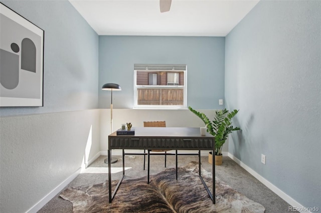 office area with baseboards, ceiling fan, and carpet