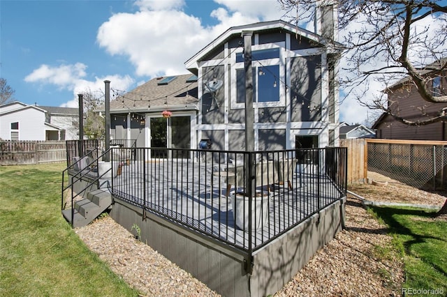 rear view of property with a yard, a chimney, a fenced backyard, and roof with shingles