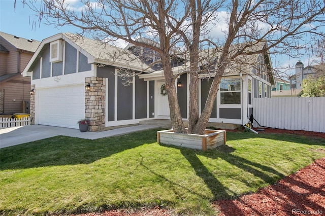 view of front of house with concrete driveway, roof with shingles, fence, and stone siding