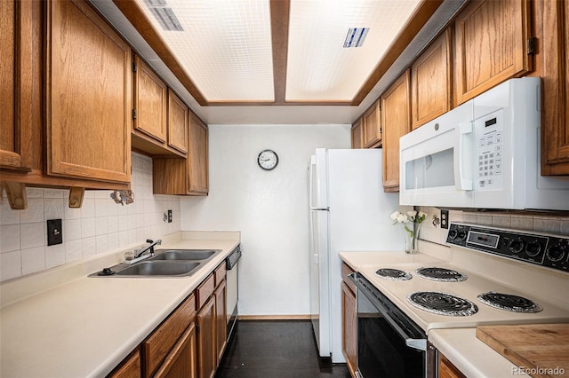 19192 E Wyoming Pl Unit 105, Aurora, CO 80017 - kitchen featuring electric range, white microwave, decorative backsplash, light countertops, and brown cabinetry