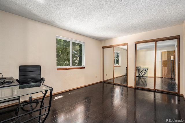 19192 E Wyoming Pl Unit 105, Aurora, CO 80017 - unfurnished room featuring a textured ceiling, hardwood / wood-style floors, and an office area