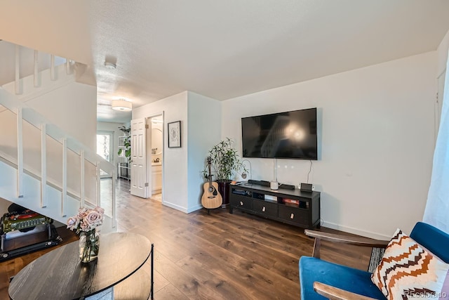 living room with hardwood / wood-style floors and a textured ceiling