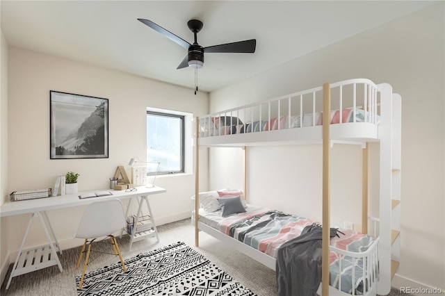 carpeted bedroom with a ceiling fan and baseboards