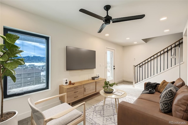 living area with recessed lighting, plenty of natural light, stairway, and baseboards