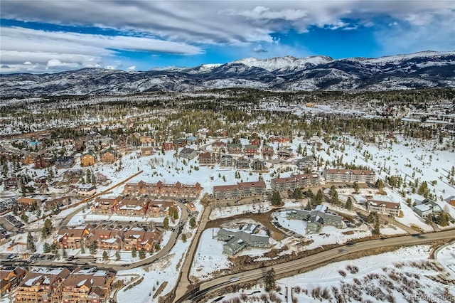 snowy aerial view featuring a residential view and a mountain view