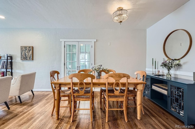 dining room with baseboards and wood finished floors