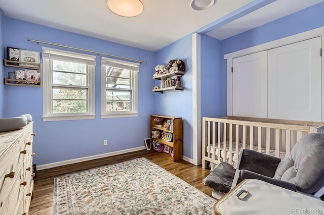 sitting room with baseboards and wood finished floors
