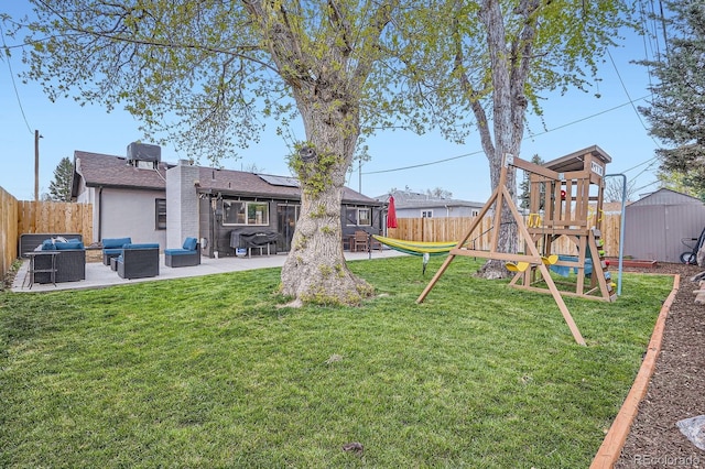 view of yard with a patio, an outdoor living space, a fenced backyard, and a playground