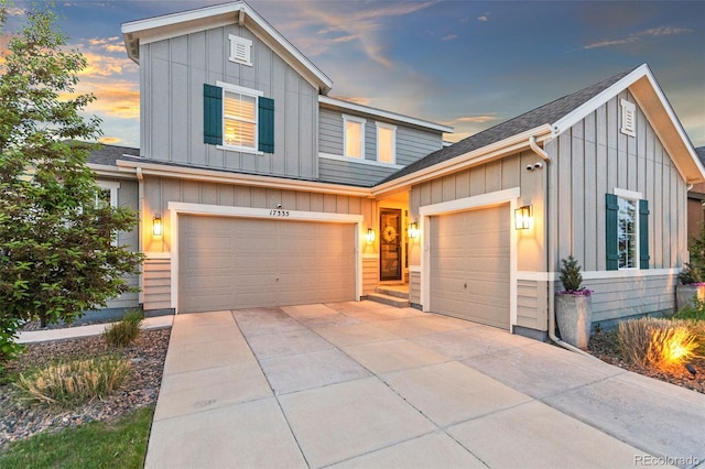 17335 W 94th Ave, Arvada, CO 80007 - view of front of home featuring board and batten siding, concrete driveway, and a garage