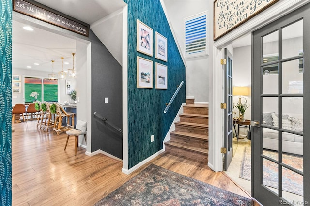 17335 W 94th Ave, Arvada, CO 80007 - stairs featuring baseboards, wood finished floors, healthy amount of natural light, and an accent wall