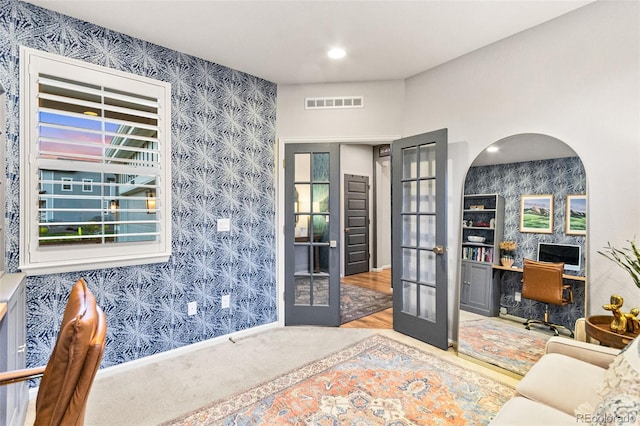 17335 W 94th Ave, Arvada, CO 80007 - home office featuring wallpapered walls, french doors, carpet floors, baseboards, and an accent wall