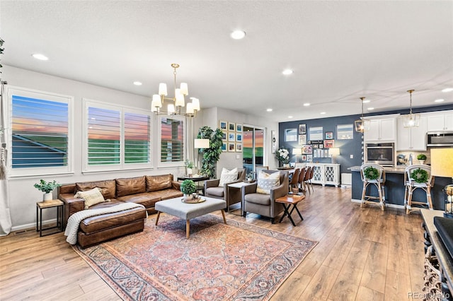 17335 W 94th Ave, Arvada, CO 80007 - living area with recessed lighting, light wood-style floors, baseboards, and a chandelier