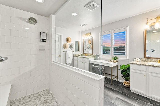 17335 W 94th Ave, Arvada, CO 80007 - full bathroom featuring a walk in shower, two vanities, and recessed lighting