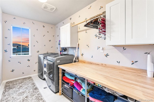 17335 W 94th Ave, Arvada, CO 80007 - laundry area with cabinet space, washer and dryer, and baseboards