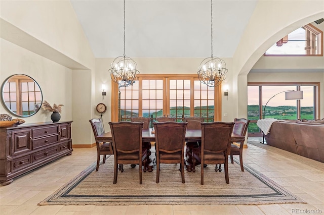 dining room with a chandelier and high vaulted ceiling