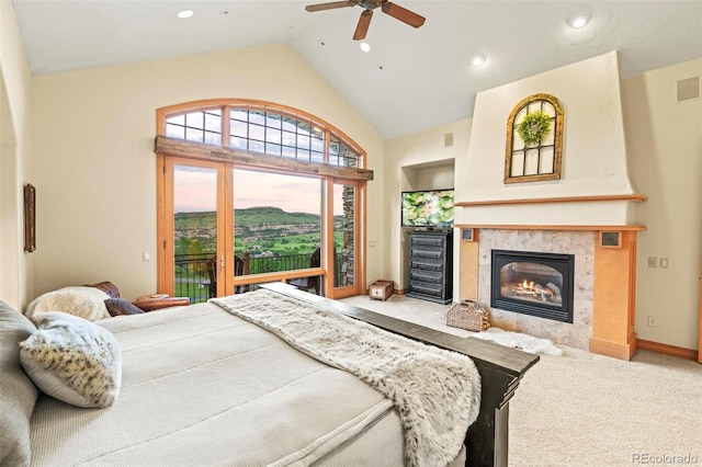 carpeted bedroom with ceiling fan, lofted ceiling, access to exterior, and a tiled fireplace