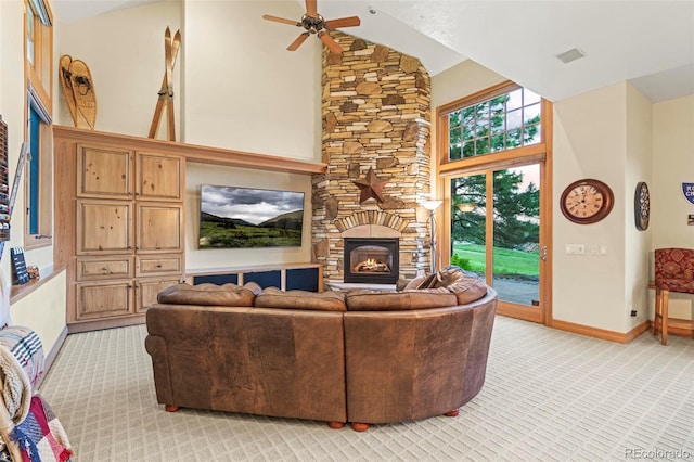 carpeted living room with ceiling fan, a fireplace, and high vaulted ceiling