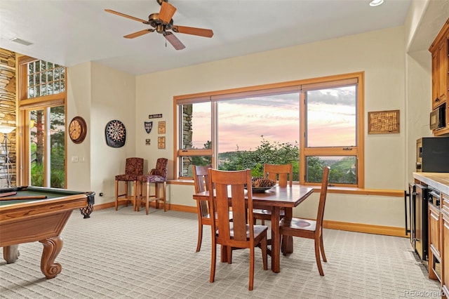 dining space with light colored carpet, beverage cooler, ceiling fan, and billiards