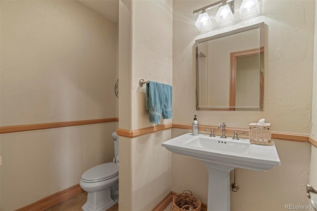 bathroom featuring sink and toilet