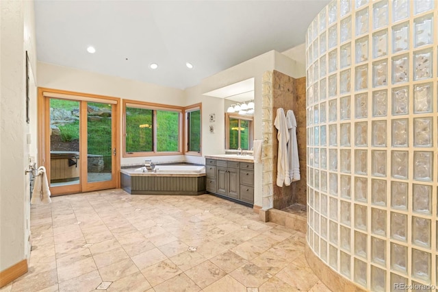 bathroom featuring vanity and independent shower and bath