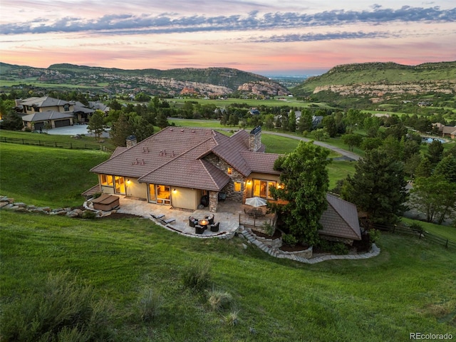 aerial view at dusk featuring a mountain view