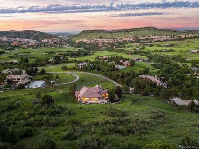 aerial view at dusk with a mountain view and a rural view