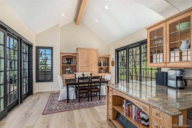 12963 Silver Elk Ln, Littleton, CO 80127 - dining room with beamed ceiling, light wood-style floors, high vaulted ceiling, healthy amount of natural light, and baseboards